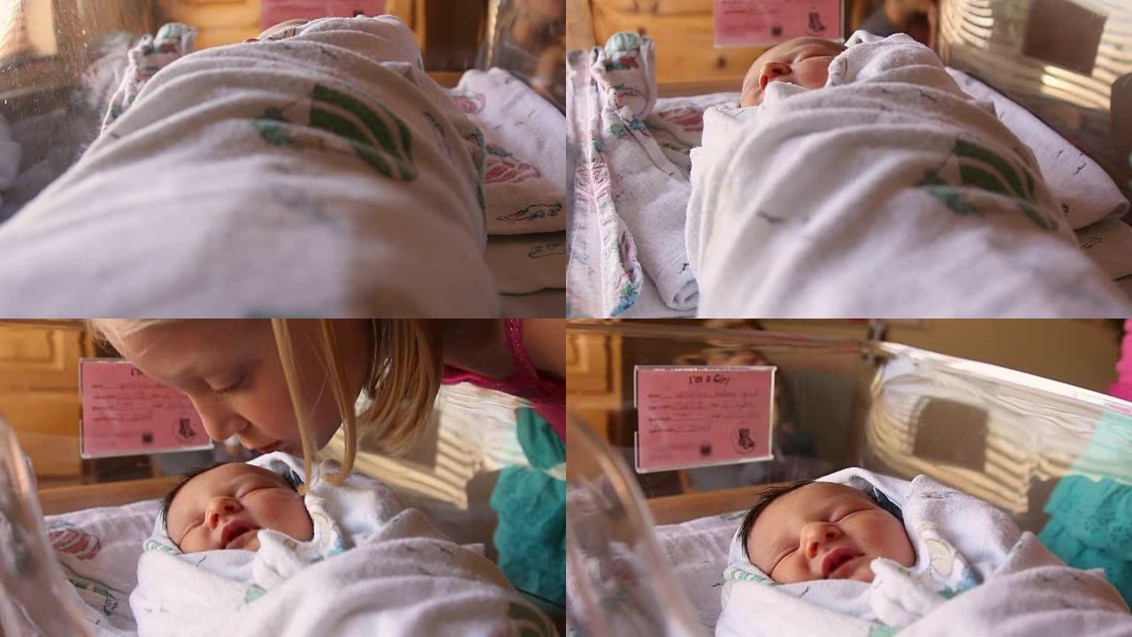 一个大姐姐在医院的婴儿床里亲吻她的新生婴儿