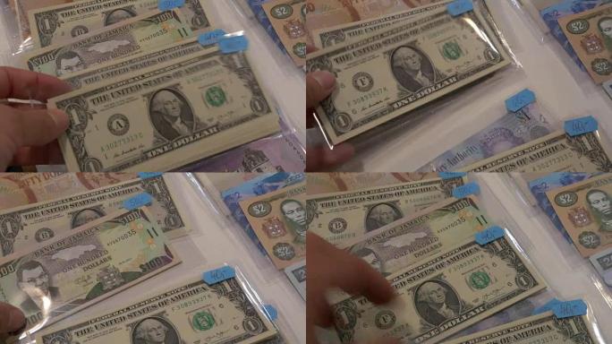 美国一美元纸币和100牙买加元
