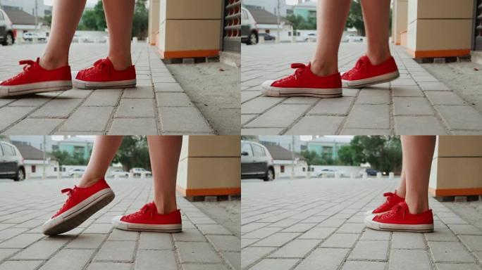 穿着红色运动鞋的女性腿迈出了一步