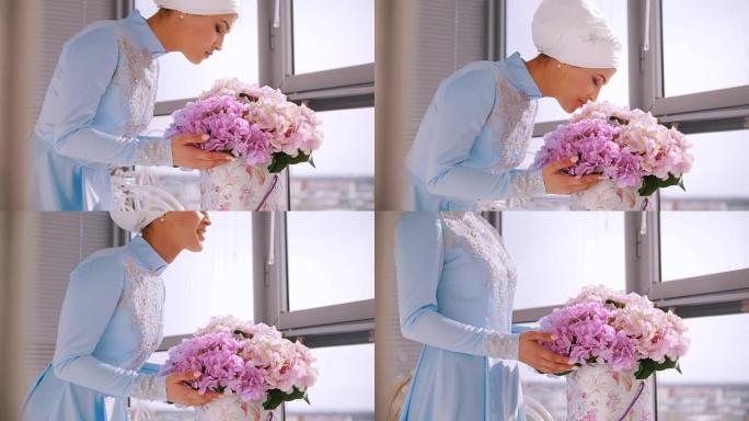 穿着蓝色婚纱的穆斯林新娘为尼迦 (nikah) 闻到鲜花