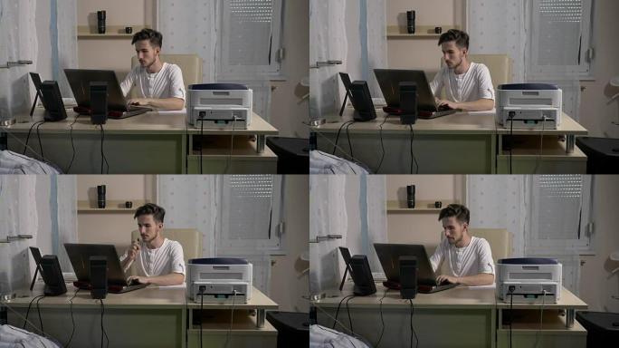 年轻的商人摄影师在家庭办公室使用笔记本电脑将他的照片在线上传到一个新项目