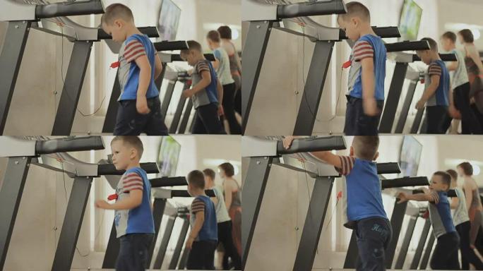 婴儿在健身房的跑步机上行走