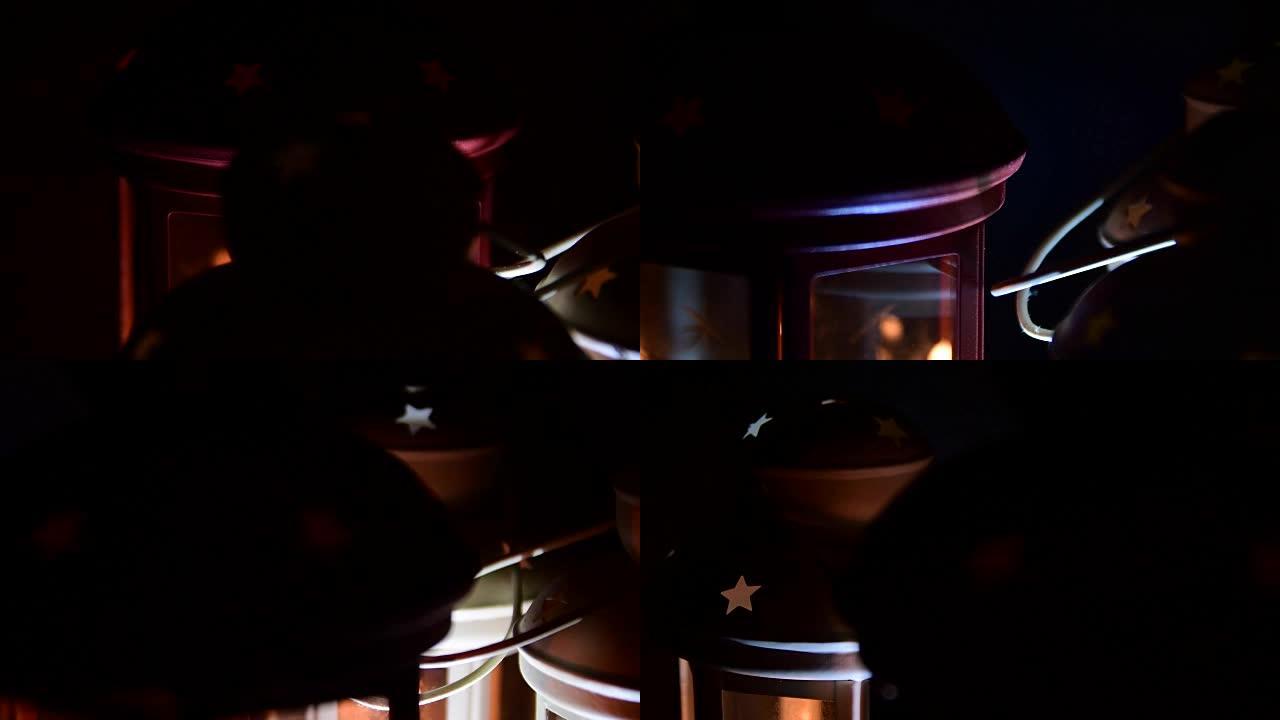 黑色背景上的灯和蜡烛。圣诞主题。