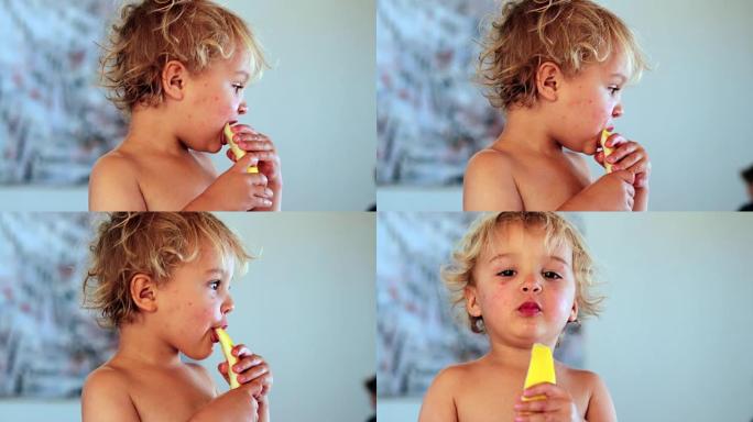 Candid moment of 2 year old baby eating melon frui