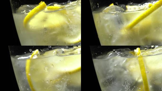 Glass of water with ice and lemon in rotation