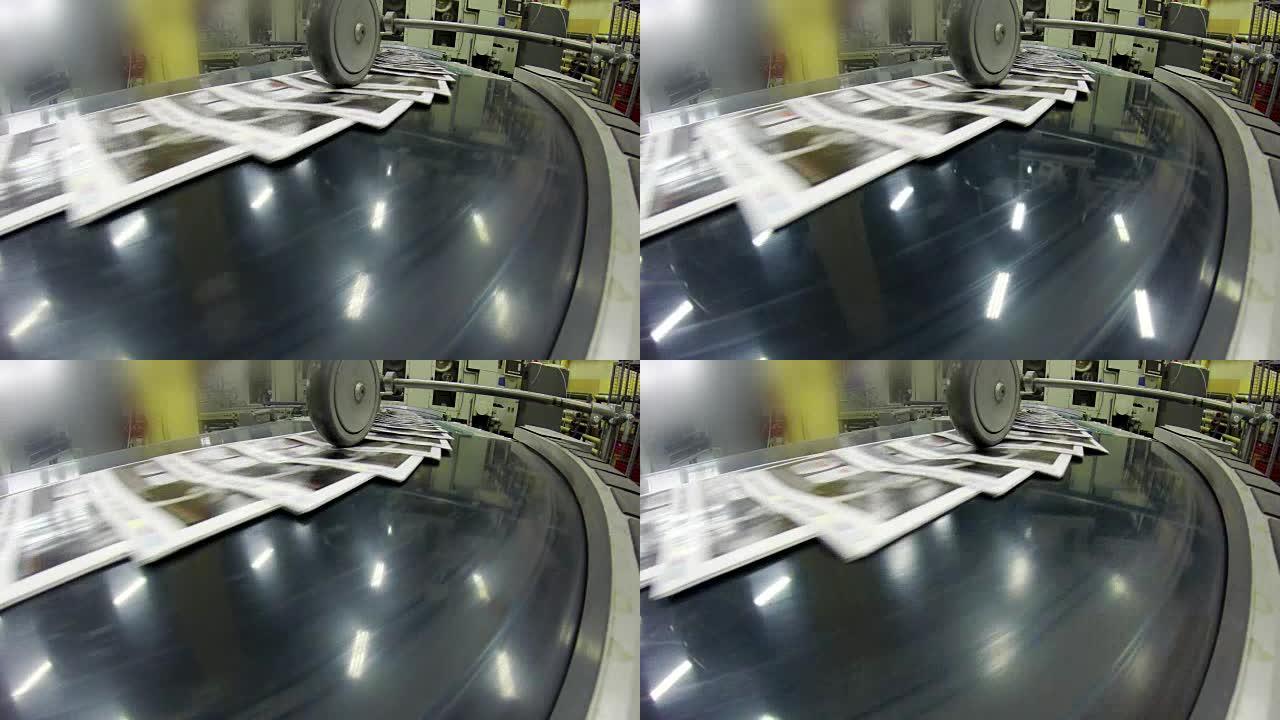 印刷厂工厂，报纸沿着装配线移动。UHD股票视频