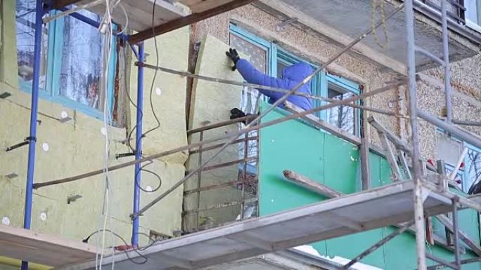 工人们温暖并修复建筑物的立面。