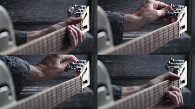 closeup of hand tuning guitar