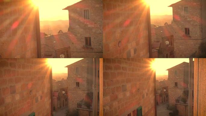 落日的光束在这座带有石板建筑的意大利小镇上