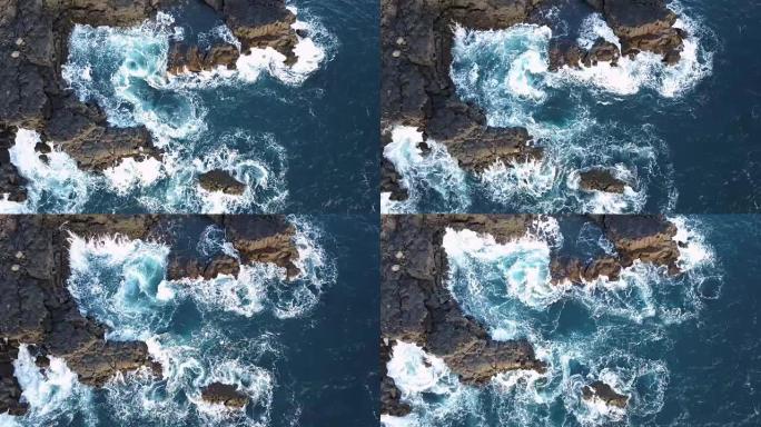 4k无人机拍摄的海浪溅到火山岩上