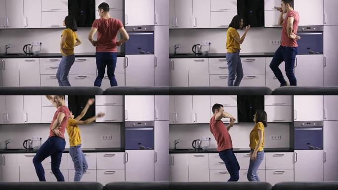 年轻的创意夫妇在厨房里的舞蹈动作