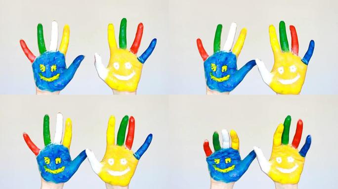肮脏的手用微笑涂上不同的颜色。幸福、好心情、快乐、创意、艺术和绘画的概念