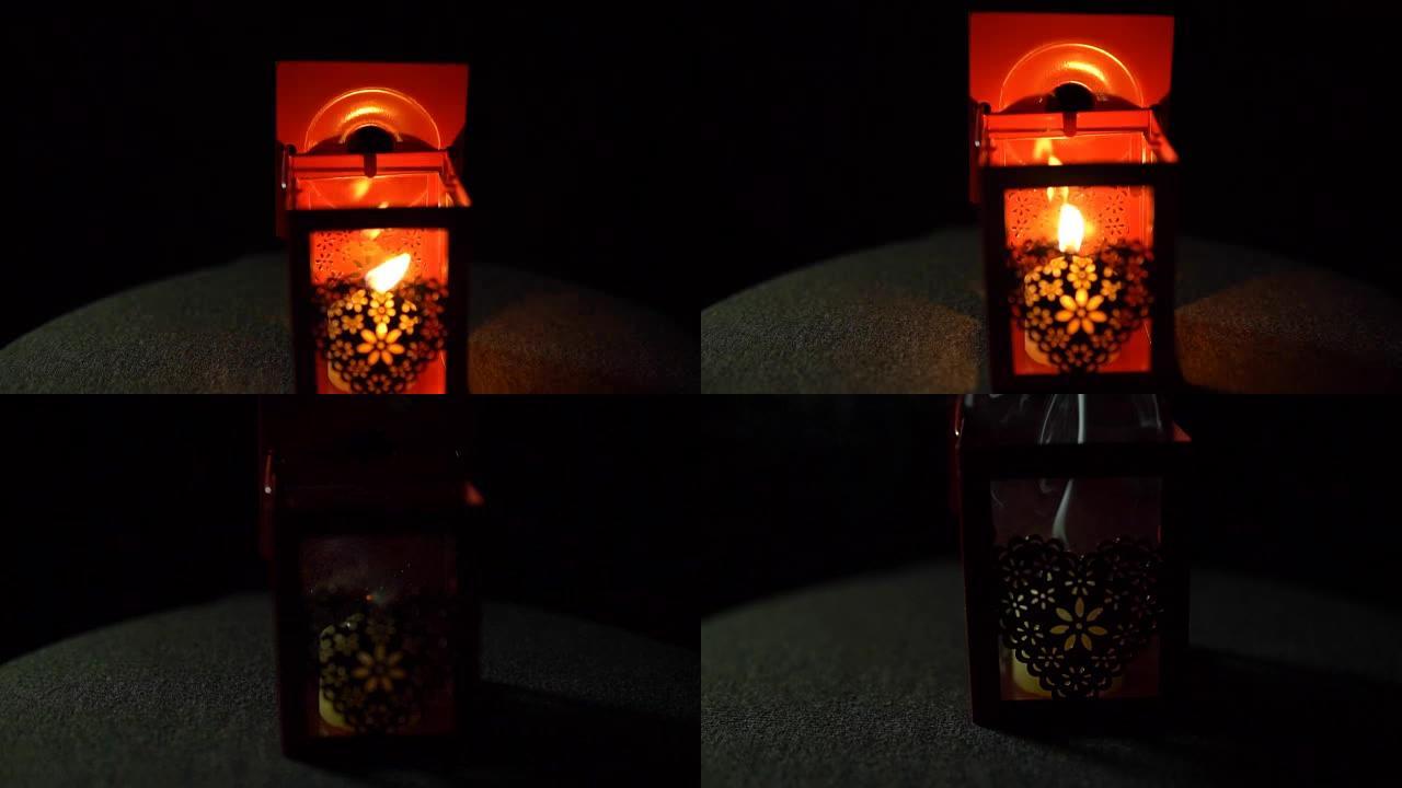 蜡烛在黑色背景的灯笼中熄灭，特写镜头。