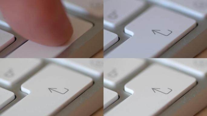 男子按下白色键盘上的输入按钮，微距拍摄