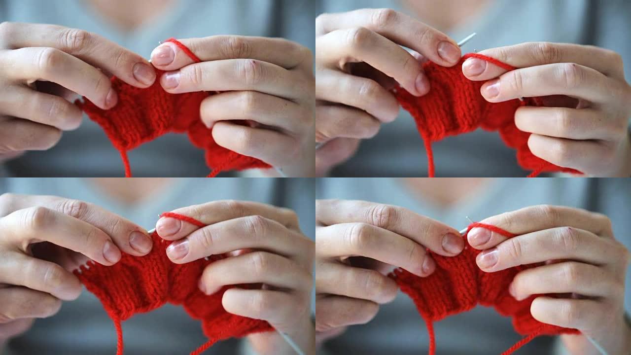 用针和红色纱线编织的女人