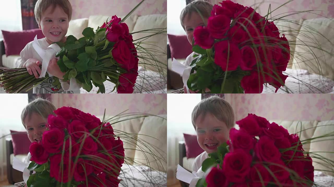 快乐宝贝捧着一大束猩红色的玫瑰花。母亲生日礼物