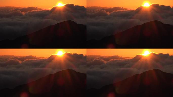 太阳冲过茂宜岛山顶的云层