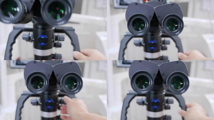 人类手臂在白色未聚焦背景上调整双目显微镜