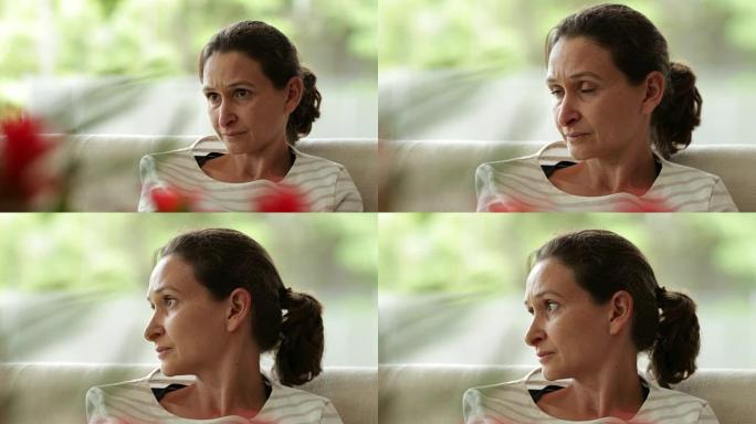 女人在听谈话时注意周围的社会动态。现实生活中真实的场景忧郁的女人脸上带着担忧的表情在4k