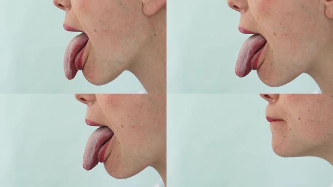显示舌头侧视图的女人的特写