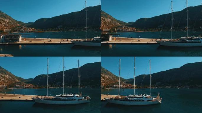 一艘大型游艇停泊在黑山科托尔湾的码头上。航拍镜头
