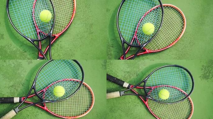 网球专业球拍和黄色球的慢动作躺在球场的绿色场地上。1920x1080