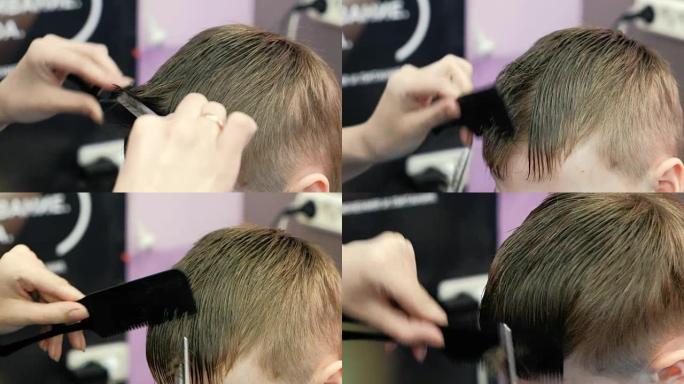 理发师的手用剪刀梳理和剪掉金色短男孩的头发，以稀疏。