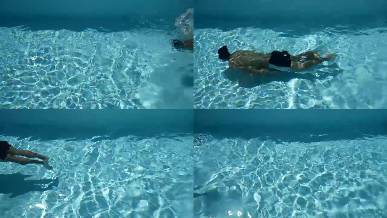 身体强健的年轻运动员在清澈的游泳池里游泳。夏季在热带地区的概念