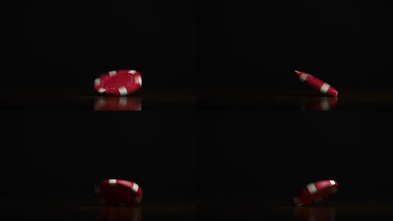 扑克筹码。扑克筹码在桌子上旋转，孤立在黑色背景上
