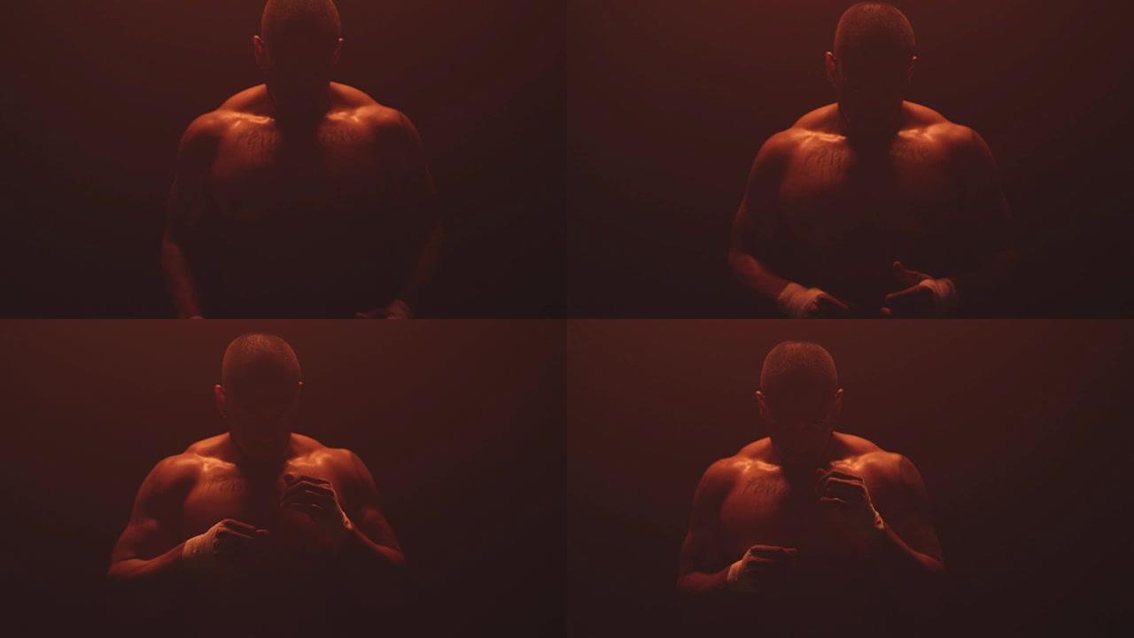 深红色背景上肌肉发达的黑人太极拳的肖像照片。