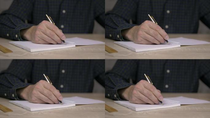 用钢笔在字帖里学习和写作的人。用钢笔把人的手记在笔记本上。