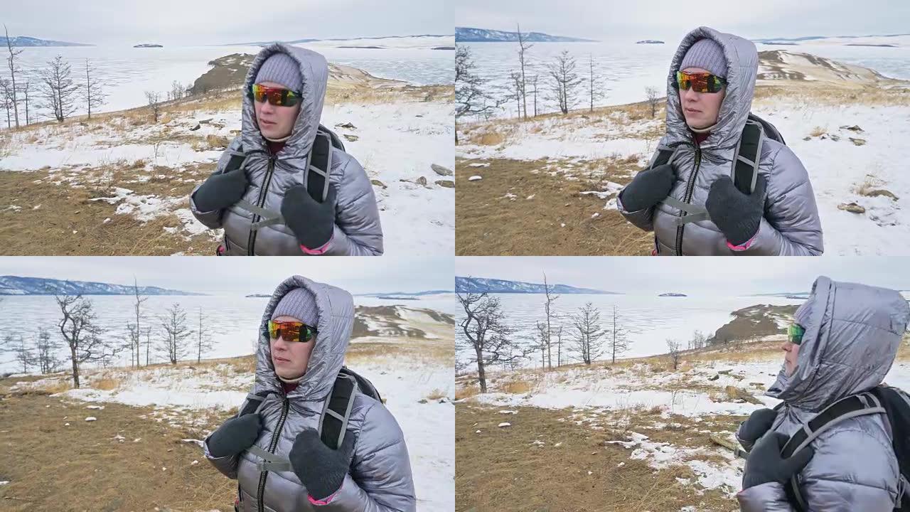 女人在贝加尔湖冰面上的旅行。闭关独特的佛塔布尔可汗纪念碑象征神秘的历史仪式岛大井山水山萨满教崇拜。冬