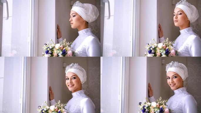 美丽的化妆穆斯林新娘看着窗外微笑