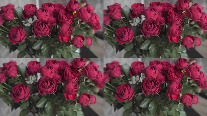关闭盛开的红玫瑰。花店、车间的鲜花。花艺、手工制作和艺术品概念