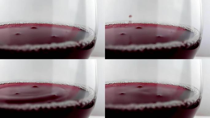 红酒掉落到白色背景的酒杯中，营养保健概念，射击