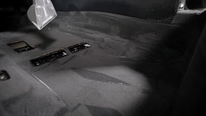 在汽车维修专业清洗过程中，洗车机在车内地毯上使用真空吸尘器