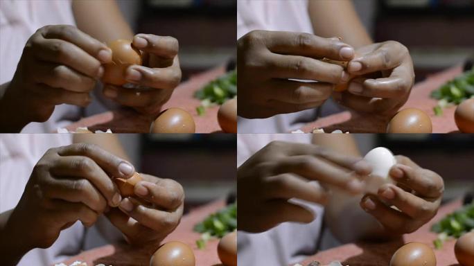 女士烹饪用肮脏的指甲去皮煮熟的鸡蛋