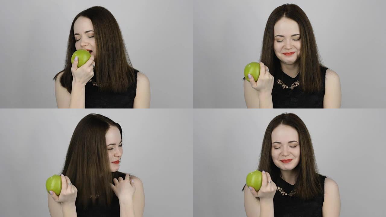 迷人的年轻女子吃了一个青苹果，微笑着