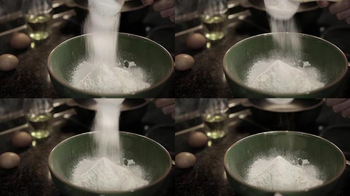 厨师在制作面团之前将面粉筛得更透气