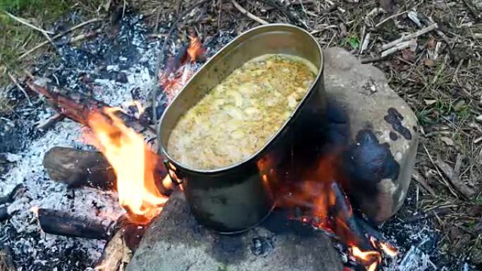 在火锅上煮汤。森林中的夏季露营