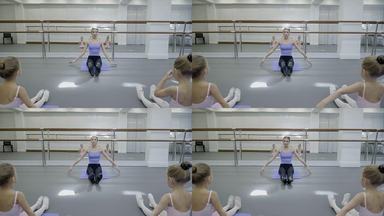 儿童芭蕾舞团的老师展示了女孩的脚尖练习