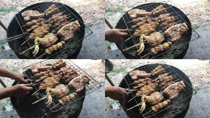 泰国街头食品: 炭烤烤鸡，火炉上的猪肉用烟半切油罐。泰式食物。泰语烧烤或泰语中的 “Moo Ping