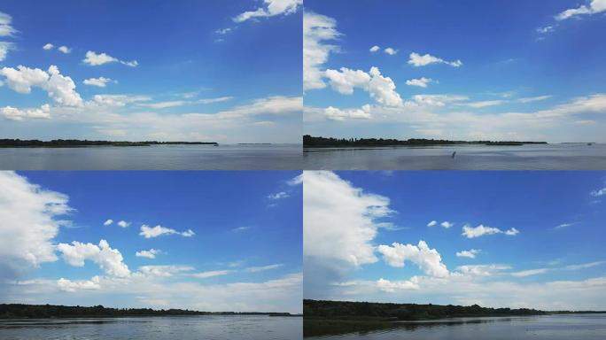 五彩缤纷的春夏季江景与美丽的云彩在天空中，从一辆沿着水路行驶的汽车拍摄，动态场景，4k视频。
