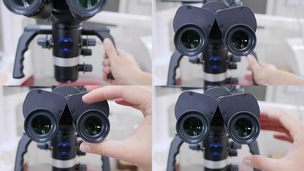人手安装现代电子显微镜的目镜特写