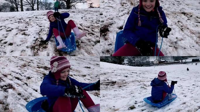 女孩在解冻的雪上雪橇