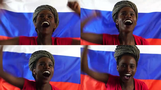 俄罗斯年轻黑人妇女举着俄罗斯国旗庆祝