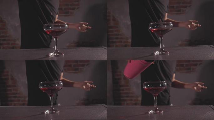 酒神以慢动作将酒精从摇床倒入玻璃中。