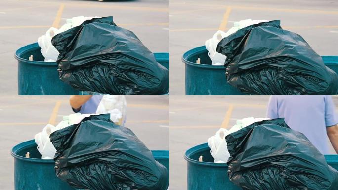一位老妇在垃圾桶里扔了一整包垃圾