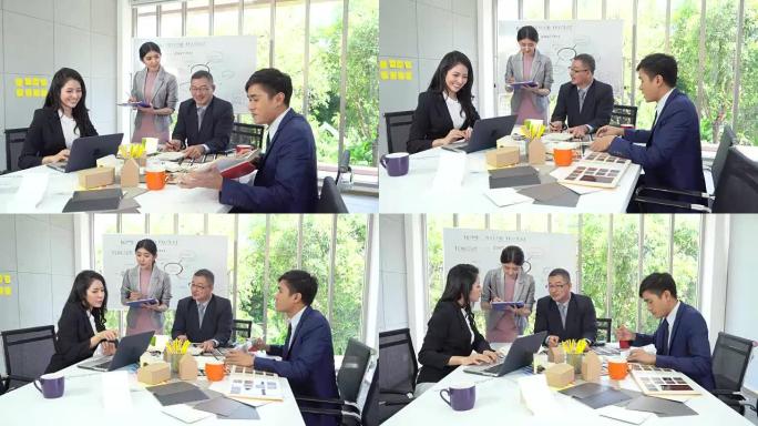 集团亚洲商务人士在现代办公室工作和集思广益，人民商务集团概念