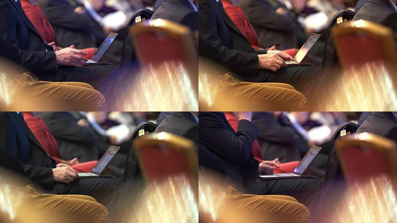 男性在笔记本电脑上的商务会议上的手
